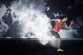 Composite image of confident male athlete running from starting blocks Royalty Free Stock Photo