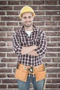 Composite image of confident male handyman wearing tool belt Royalty Free Stock Photo