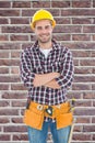 Composite image of confident male handyman wearing tool belt Royalty Free Stock Photo