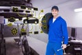 Composite image of confident mechanic carrying tire Royalty Free Stock Photo