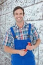 Composite image of confident plumber holding monkey wrench Royalty Free Stock Photo