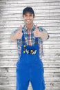 Composite image of confident plumber showing thumbs up sign