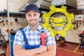 Composite image of confident young male repairman holding adjustable spanner Royalty Free Stock Photo