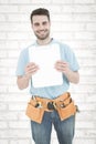 Composite image of construction worker showing blank paper on clipboard Royalty Free Stock Photo