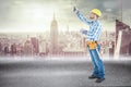 Composite image of construction worker using measure tape Royalty Free Stock Photo