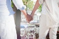 Composite image of couple on the beach looking out to sea holding hands Royalty Free Stock Photo