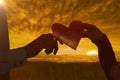 Composite image of couple hands holding heart shaped paper Royalty Free Stock Photo