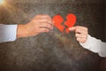 Composite image of couple holding broken heart shape paper Royalty Free Stock Photo