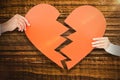 Composite image of couple holding broken heart shape paper Royalty Free Stock Photo