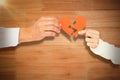 Composite image of couple holding broken heart shape paper Royalty Free Stock Photo