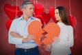 Composite image of couple holding broken heart shape paper 3d Royalty Free Stock Photo