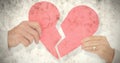Composite image of couple holding a broken paper heart Royalty Free Stock Photo