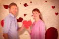 Composite image of couple holding a red heart Royalty Free Stock Photo