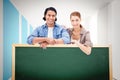 Composite image of couple leaning on blank wall Royalty Free Stock Photo