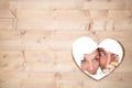 Composite image of couple looking through torn paper Royalty Free Stock Photo