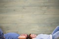 Composite image of couple lying on the floor Royalty Free Stock Photo