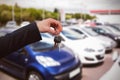 Composite image of couple receiving car keys by a dealer Royalty Free Stock Photo