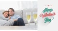 Composite image of couple resting on a couch with flutes of champagne Royalty Free Stock Photo