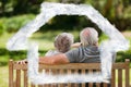 Composite image of couple sitting on the bench with their back to the camera Royalty Free Stock Photo