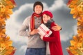 Composite image of couple smiling and holding gift Royalty Free Stock Photo