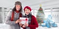 Composite image of couple smiling and holding gift Royalty Free Stock Photo