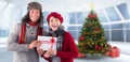 Composite image of couple smiling and holding gift Royalty Free Stock Photo