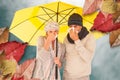 Composite image of couple sneezing in tissue while standing under umbrella Royalty Free Stock Photo