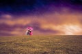 Composite image of couple standing underneath an umbrella Royalty Free Stock Photo