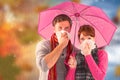 Composite image of couple standing underneath an umbrella Royalty Free Stock Photo