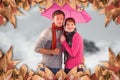 Composite image of couple standing underneath an umbrella Royalty Free Stock Photo