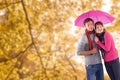 Composite image of couple standing underneath an umbrella Royalty Free Stock Photo