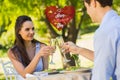 Composite image of couple toasting champagne flutes at an outdoor cafÃÂ©