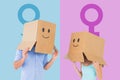 Composite image of couple wearing emoticon face boxes on their heads