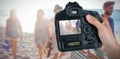 Composite image of cropped hand of photographer holding camera Royalty Free Stock Photo