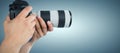 Composite image of cropped hands of photographer holding digital camera Royalty Free Stock Photo
