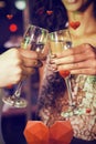 Composite image of cropped image of hand toasting champagne glasses