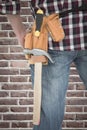 Composite image of cropped image of handyman wearing tool belt Royalty Free Stock Photo