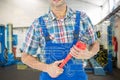 Composite image of cropped image of plumber holding monkey wrench Royalty Free Stock Photo