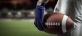 Composite image of cropped image of sportsman holding american football ball ball Royalty Free Stock Photo