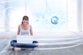 Composite image of cross legged woman using a laptop Royalty Free Stock Photo