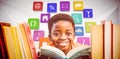 Composite image of cute boy reading book in library Royalty Free Stock Photo