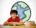 Composite image of cute boy reading book in library Royalty Free Stock Photo