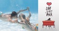 Composite image of cute couple kissing underwater in the swimming pool Royalty Free Stock Photo