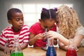 Composite image of cute pupil looking through microscope Royalty Free Stock Photo