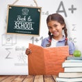 Composite image of cute pupil smiling at camera during class presentation