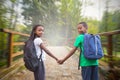 Composite image of cute pupils holding hands Royalty Free Stock Photo