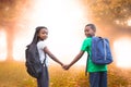 Composite image of cute pupils holding hands Royalty Free Stock Photo