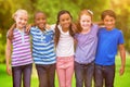 Composite image of cute pupils smiling at camera in classroom Royalty Free Stock Photo