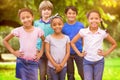 Composite image of cute pupils smiling at camera in classroom Royalty Free Stock Photo