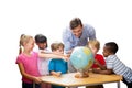 Composite image of cute pupils and teacher looking at globe in library Royalty Free Stock Photo